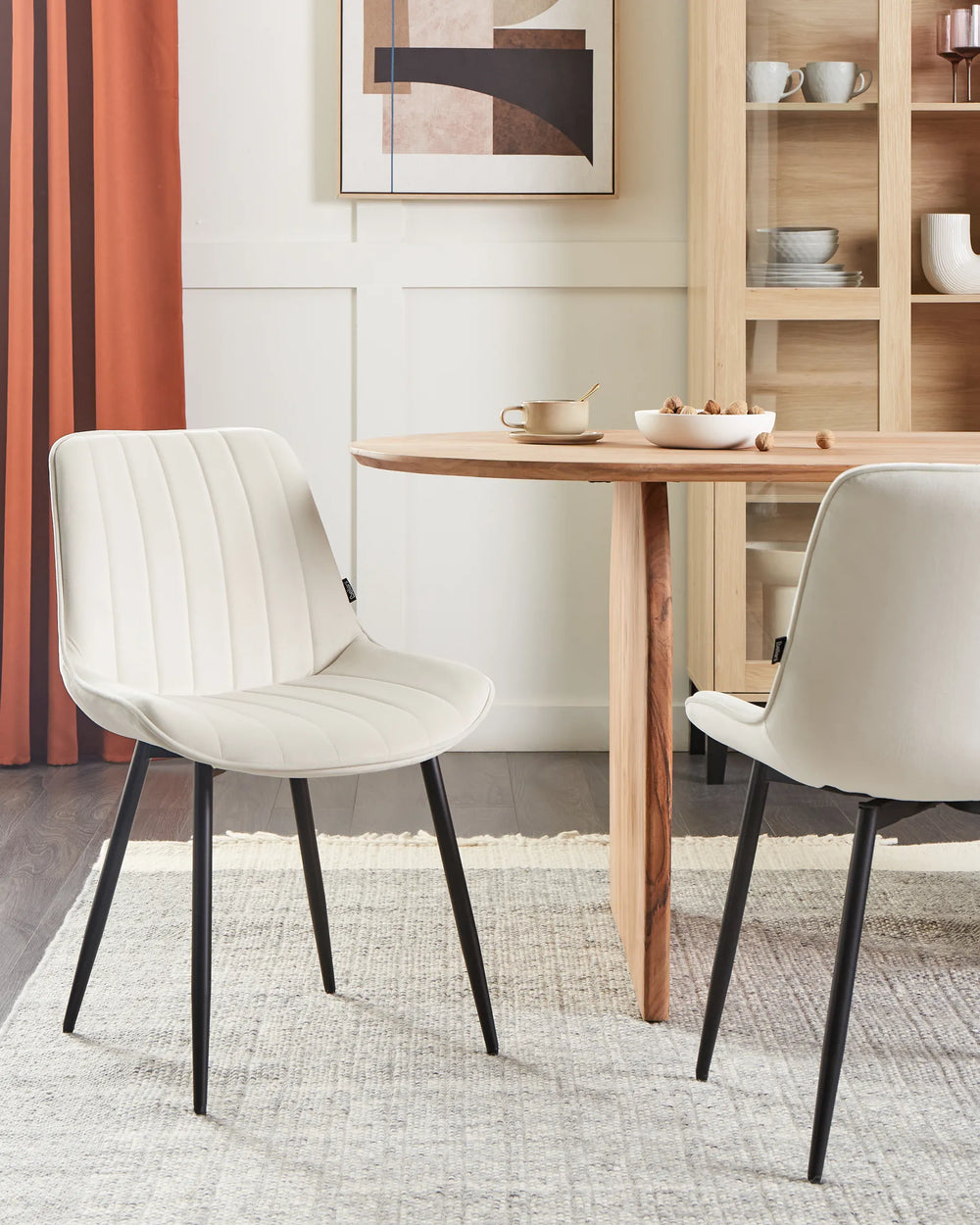 Contemporary dining setting featuring the chair’s soft neutral tones paired with natural wood elements, creating a bright and inviting atmosphere.