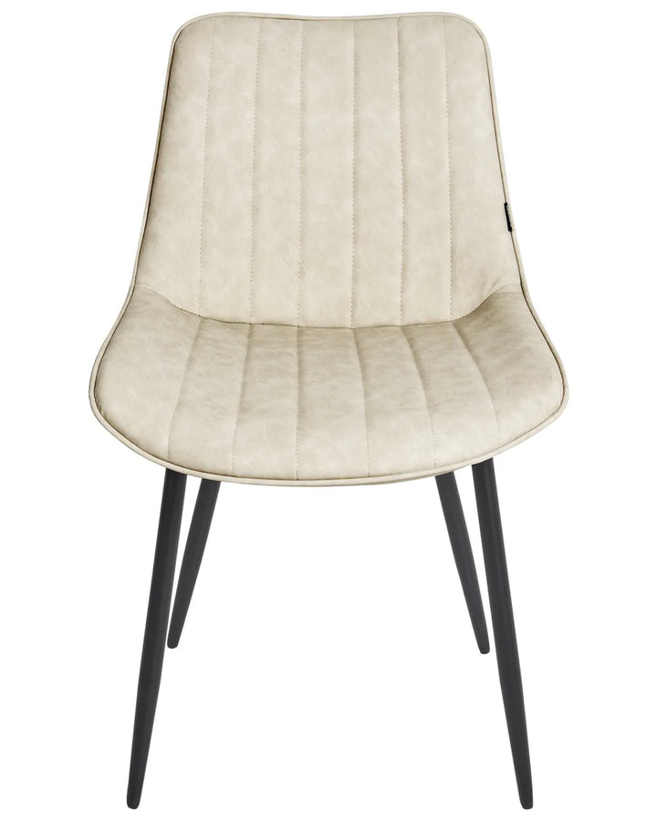 Light beige faux leather dining chair with vertical stitched detailing, a gently curved silhouette, and slim black metal legs for a modern, minimalist look.