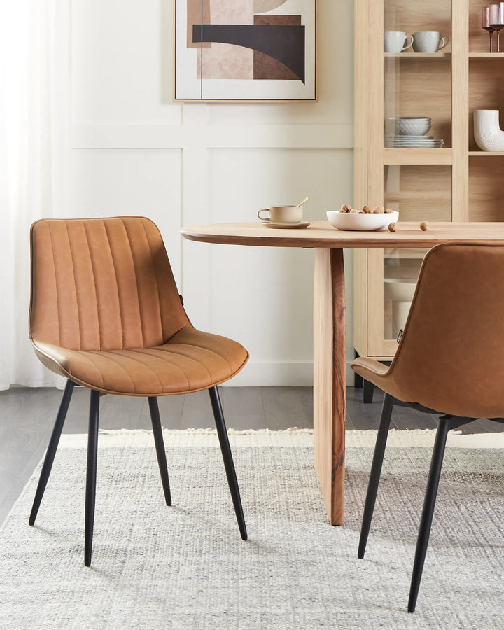 Stylish dining space featuring warm brown chairs paired with a natural wood table, creating a cozy and contemporary atmosphere.