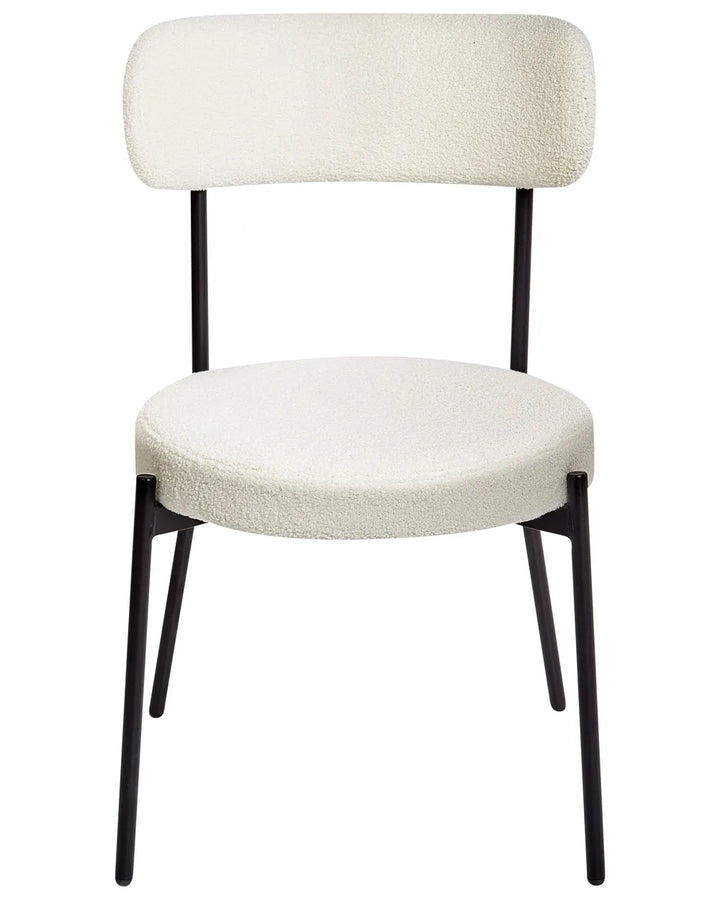 Off-white bouclé dining chair with a curved backrest and black metal legs.
