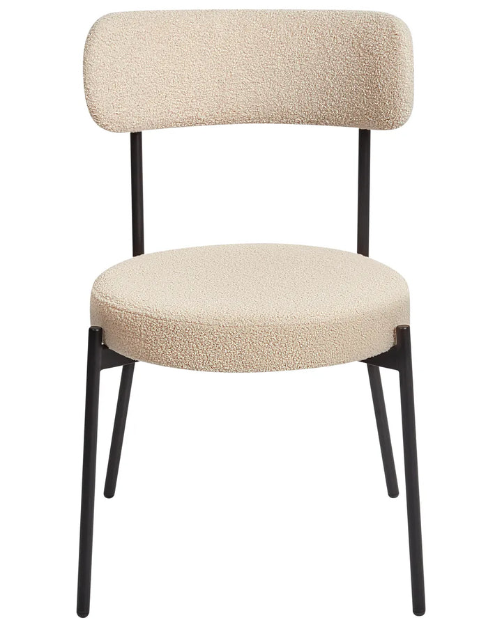 Cream bouclé dining chair with a rounded seat, curved backrest, and black metal legs.