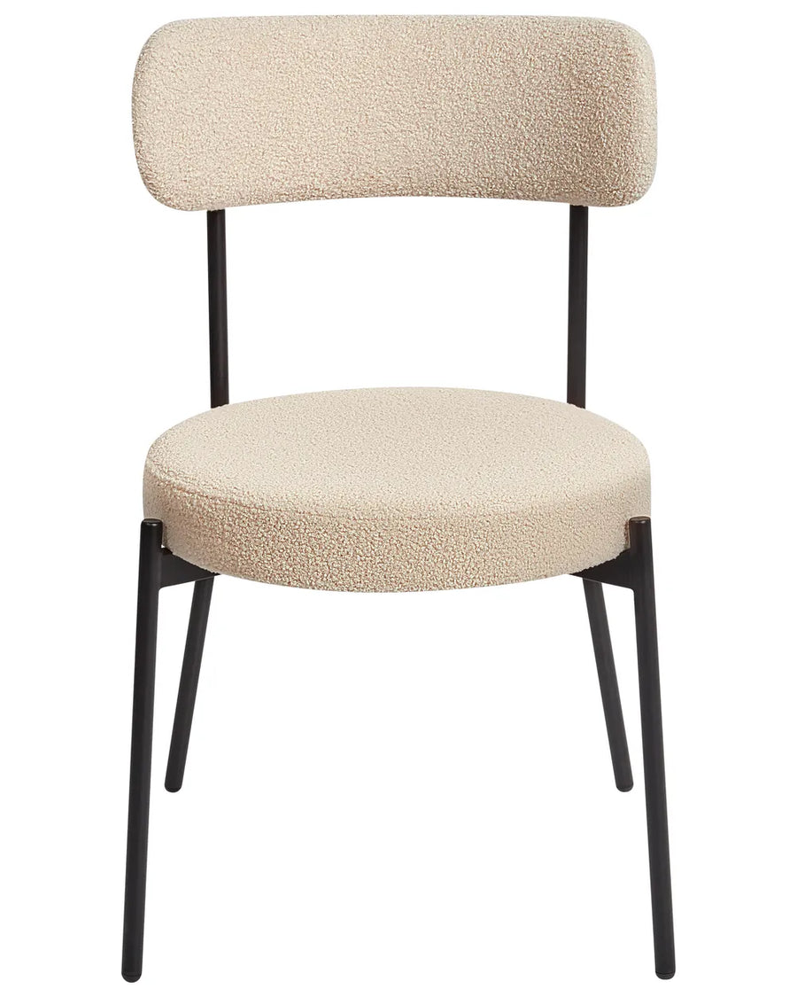 Cream bouclé dining chair with a rounded seat, curved backrest, and black metal legs.
