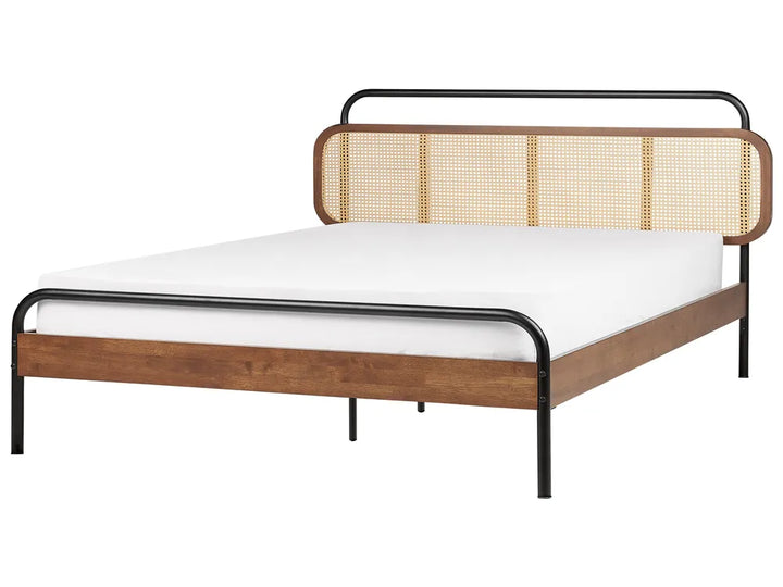 Bed with wooden frame and woven backrest on a white background