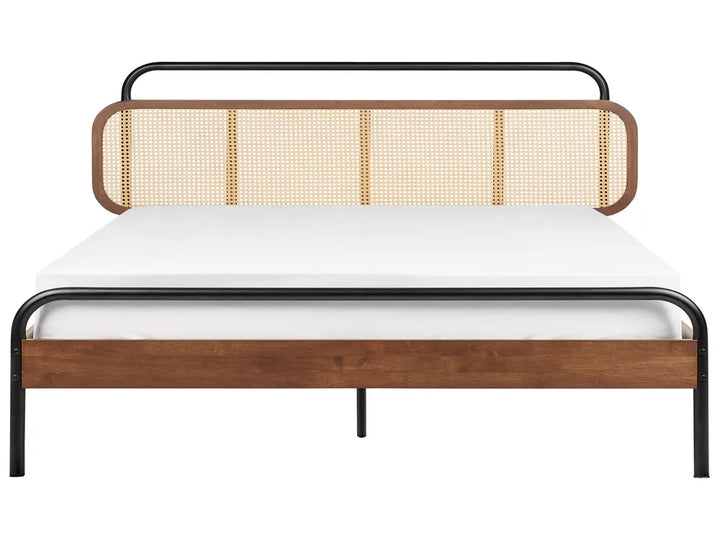 Bed with wooden and rattan headboard on a white background