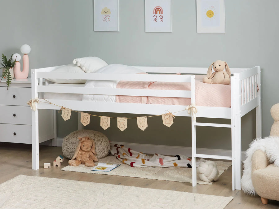 Children's room with a white bed, toys, and decorative elements.
