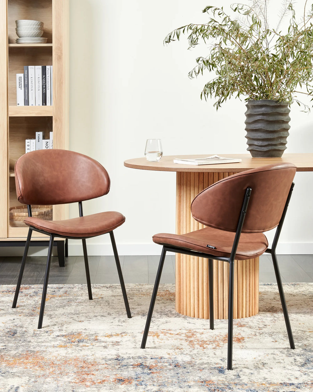 Contemporary dining setting showcasing the chair’s warm brown upholstery, paired with natural wood furniture and minimalist décor for a cozy, sophisticated atmosphere.