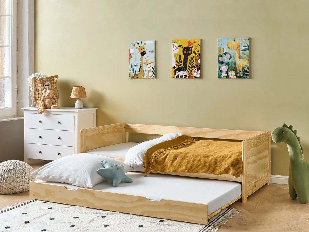 Children's bedroom with wooden bed, white dresser, and colorful wall art.