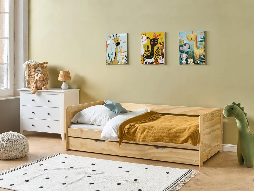 Children's bedroom with a wooden bed, white dresser, and colorful wall art.