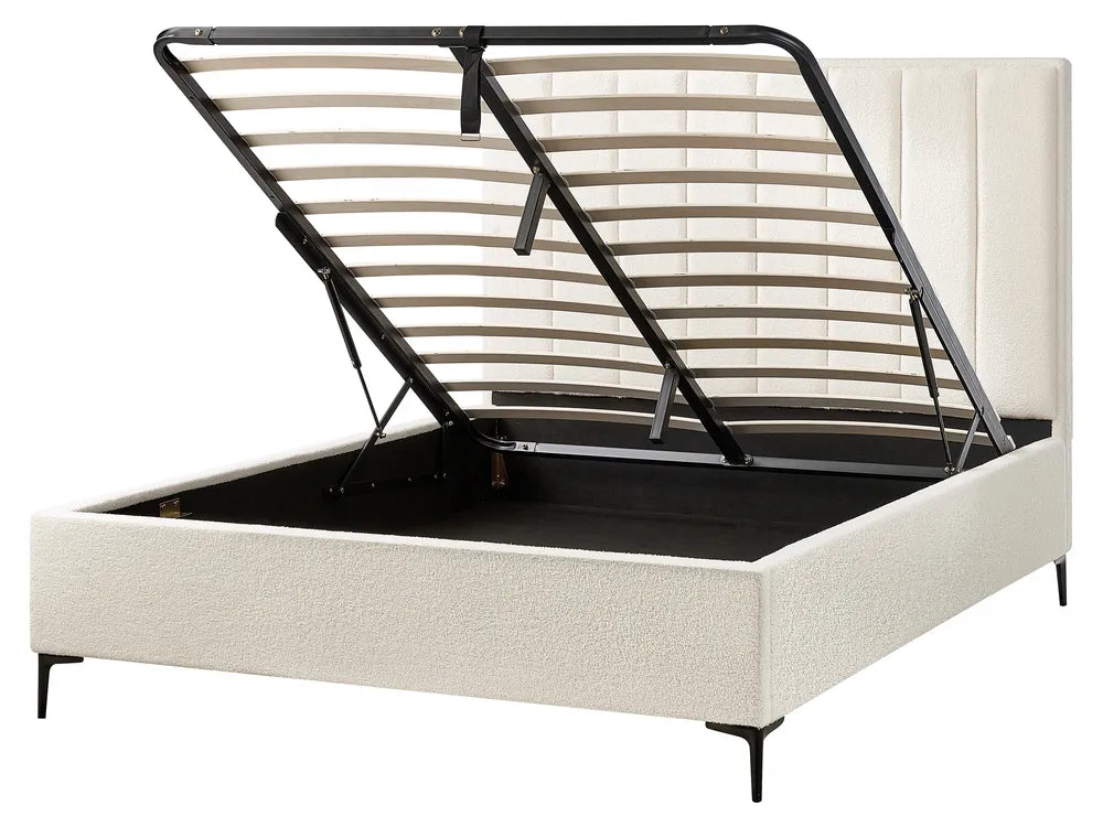 Beige upholstered bed frame with black metal slat support 