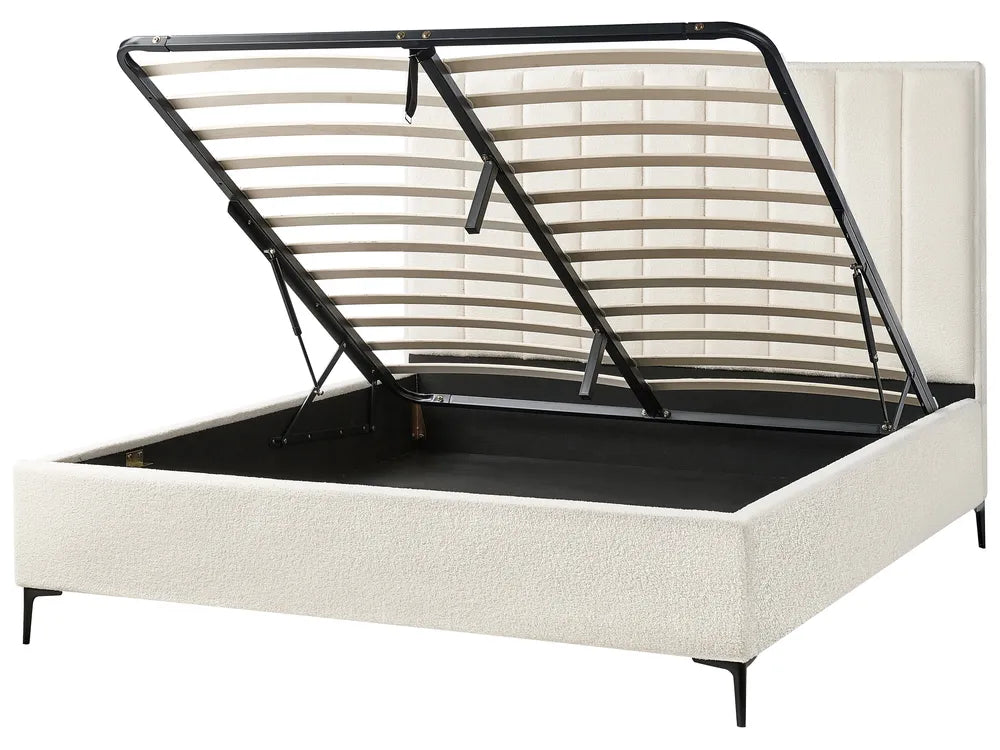 Beige upholstered bed with black metal frame
