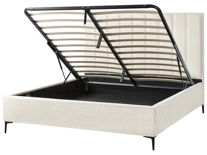 Beige upholstered bed with black metal frame