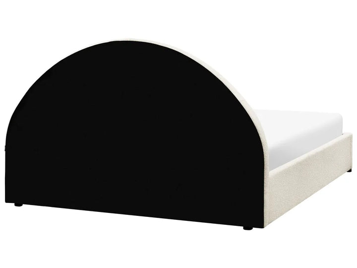 Black and white bed frame with curved design on a white background