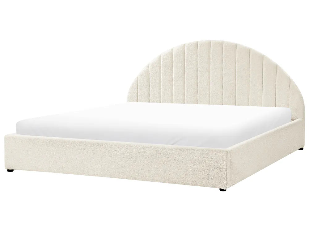 White bed with a curved headboard on a white background