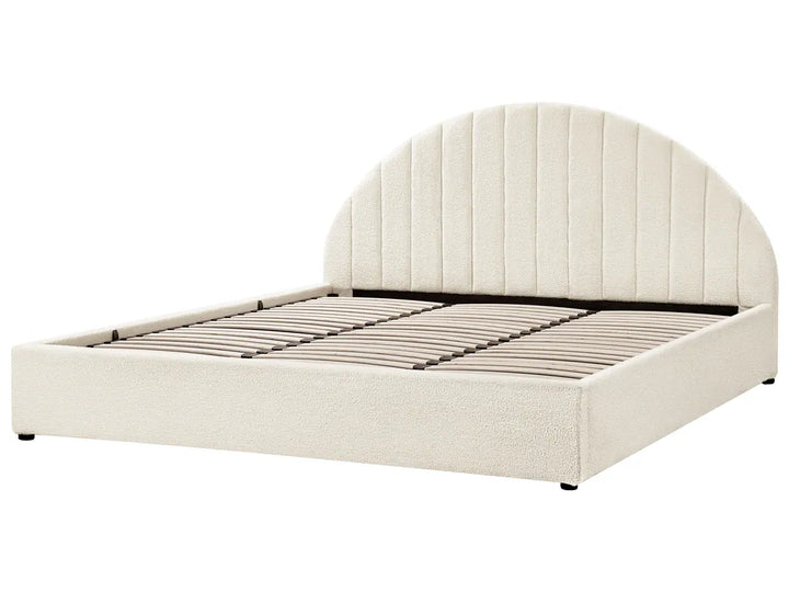 Beige upholstered bed with a tufted headboard on a white background