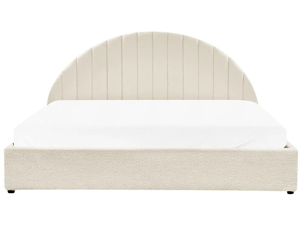 Beige upholstered bed with white bedding on a white background