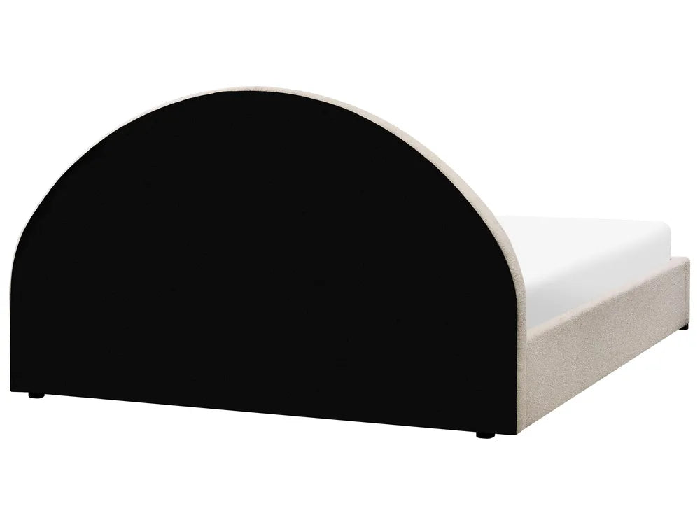 Bed with black and white headboard on a white background