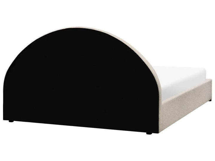 Bed with black and white headboard on a white background