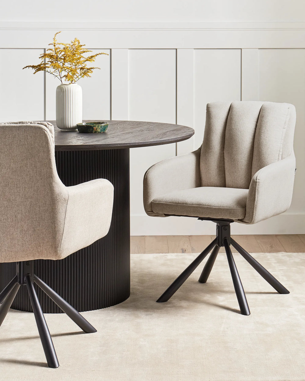 Beige swivel dining chair styled around a contemporary dining table in a bright neutral interior. Warm textures, natural light, and modern décor create a cozy and sophisticated atmosphere.