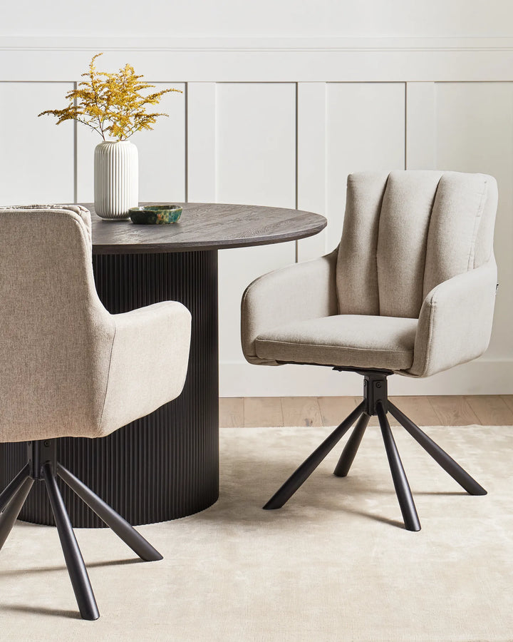 Beige swivel dining chair styled around a contemporary dining table in a bright neutral interior. Warm textures, natural light, and modern décor create a cozy and sophisticated atmosphere.