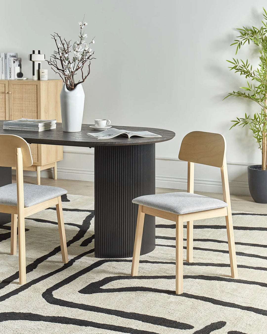 Styled around a contemporary dining table, this chair enhances the space with its clean lines, natural wood tones, and understated Scandinavian-inspired charm.