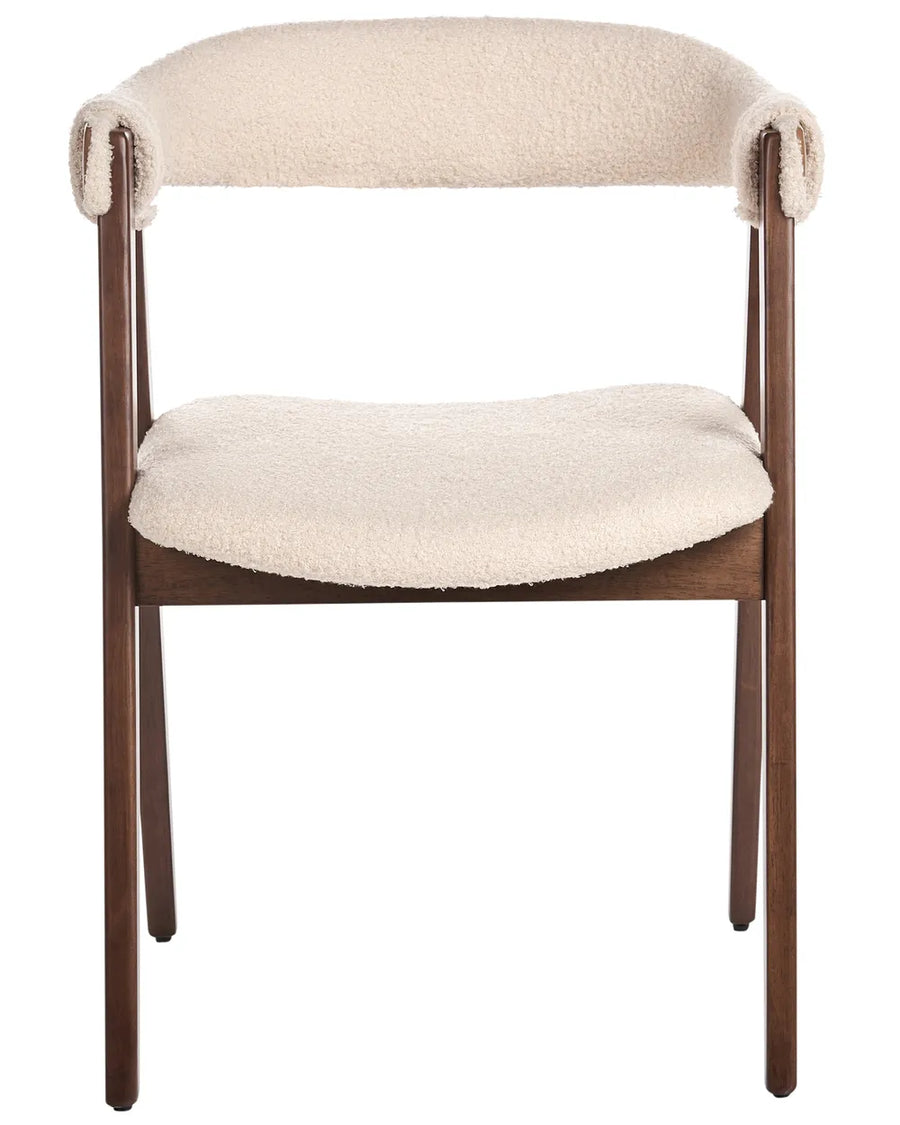 Bouclé dining chair with a curved open-back design, plush padded seat, and dark wood frame for a warm modern look.