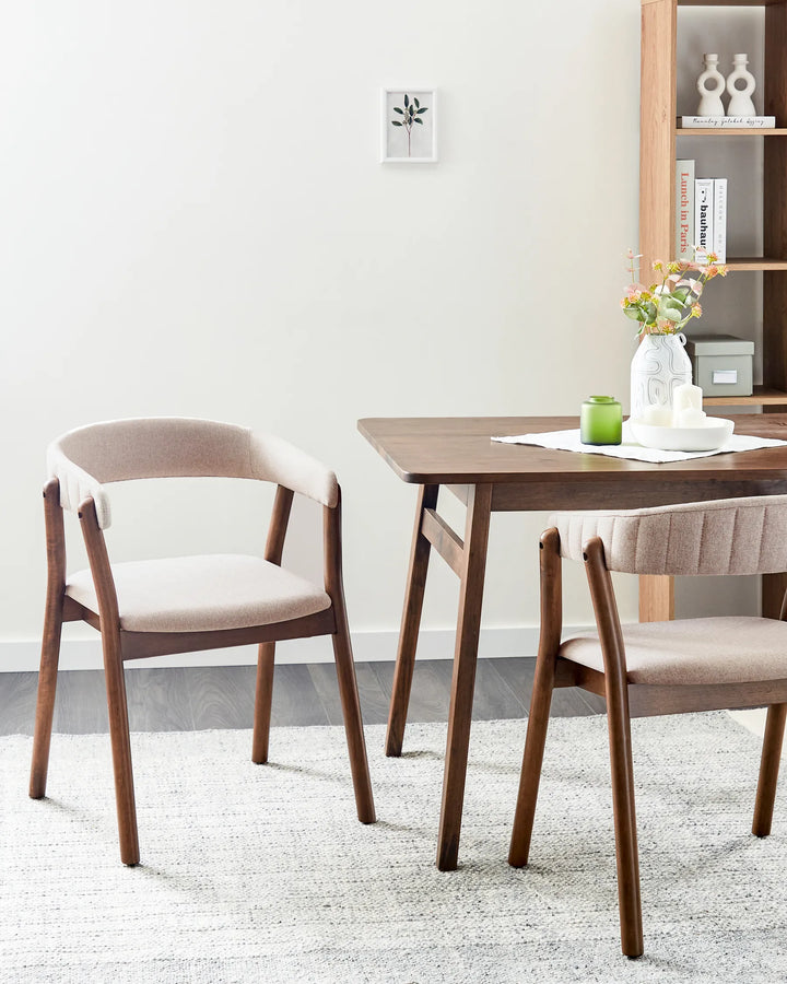Warm, contemporary dining setting featuring upholstered wood-framed chairs that bring natural elegance and everyday comfort.