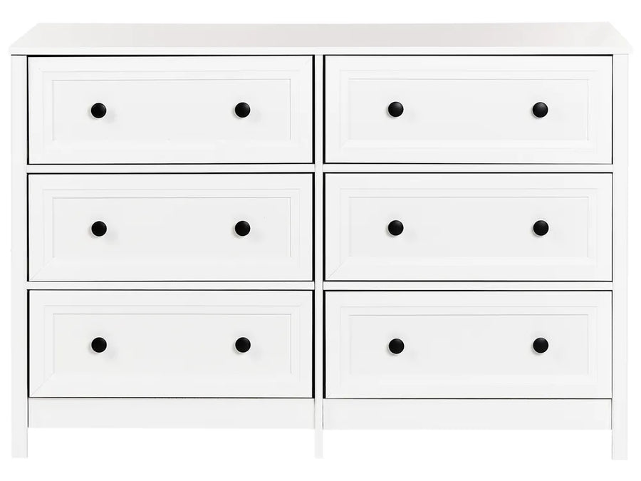 White dresser with six drawers and black knobs on a white background