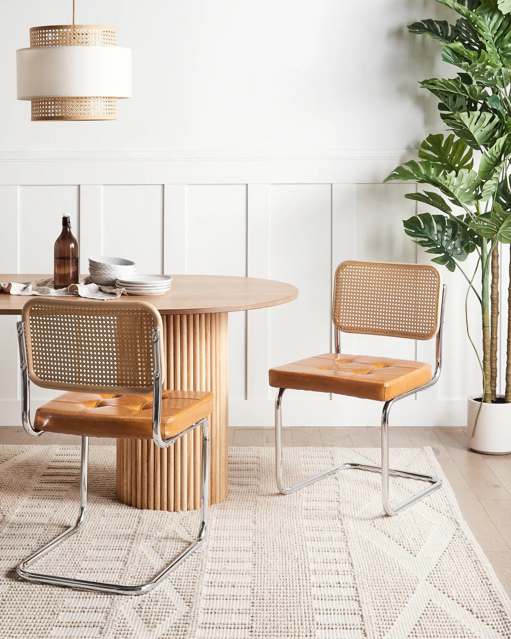Paired with a natural wood dining table, these contemporary cantilever chairs add warmth, texture, and vintage charm while creating an inviting dining space.