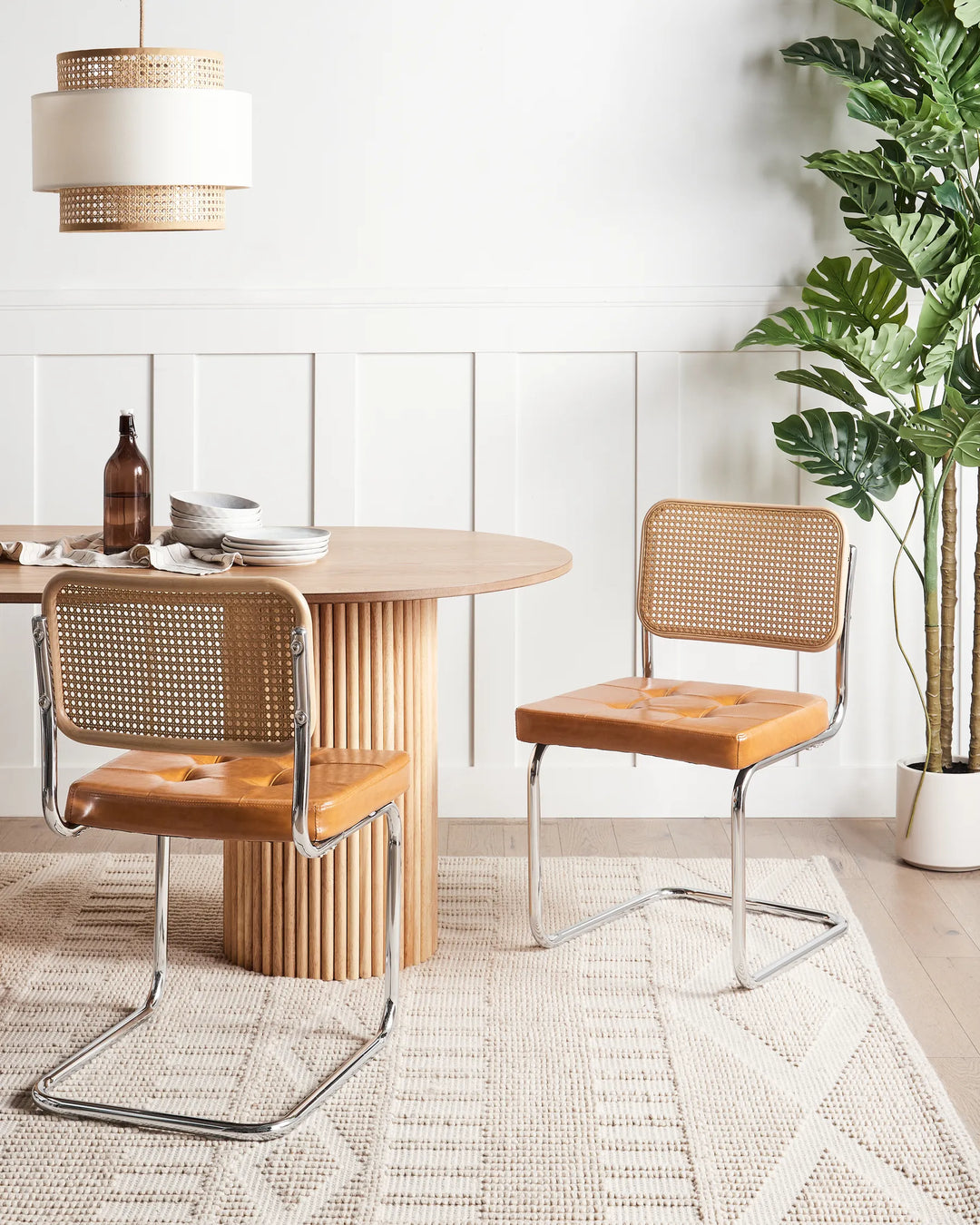 Paired with a natural wood dining table, these contemporary cantilever chairs add warmth, texture, and vintage charm while creating an inviting dining space.