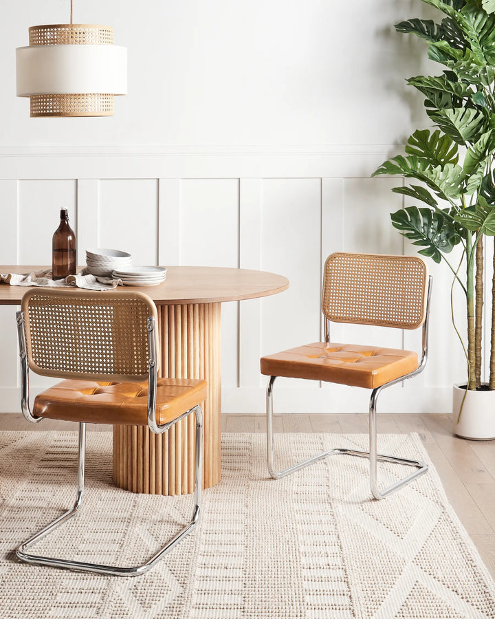 Paired with a natural wood dining table, these contemporary cantilever chairs add warmth, texture, and vintage charm while creating an inviting dining space.