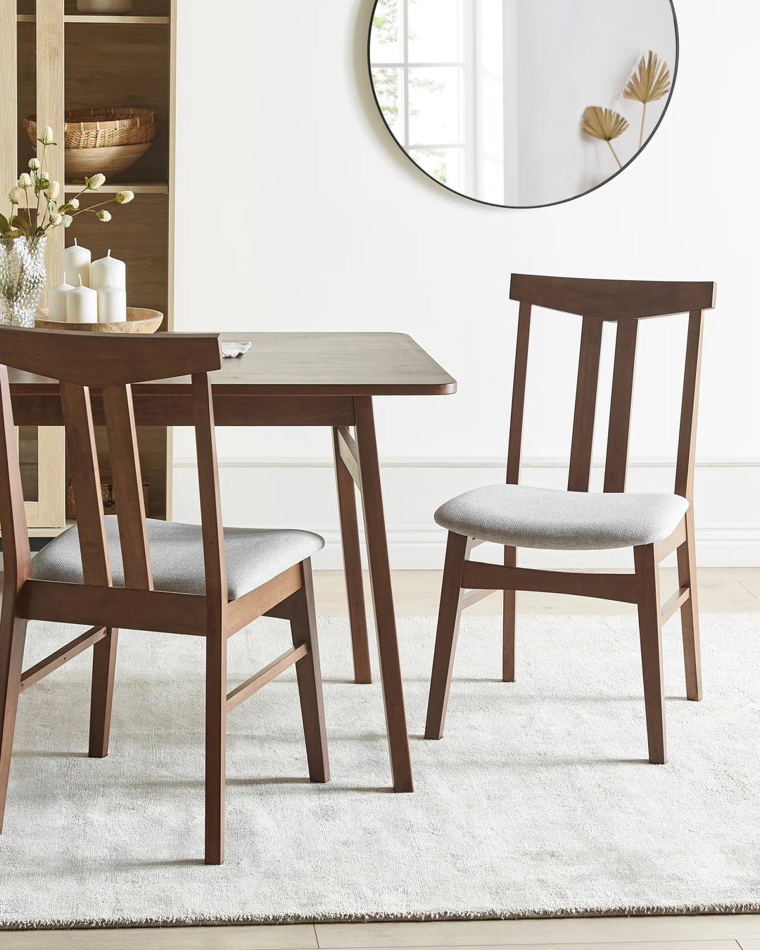 Styled around a coordinating dining table, this dark wood dining chair brings warmth and sophistication to the dining area. The contrasting grey upholstery softens the look, creating a welcoming and refined setting.