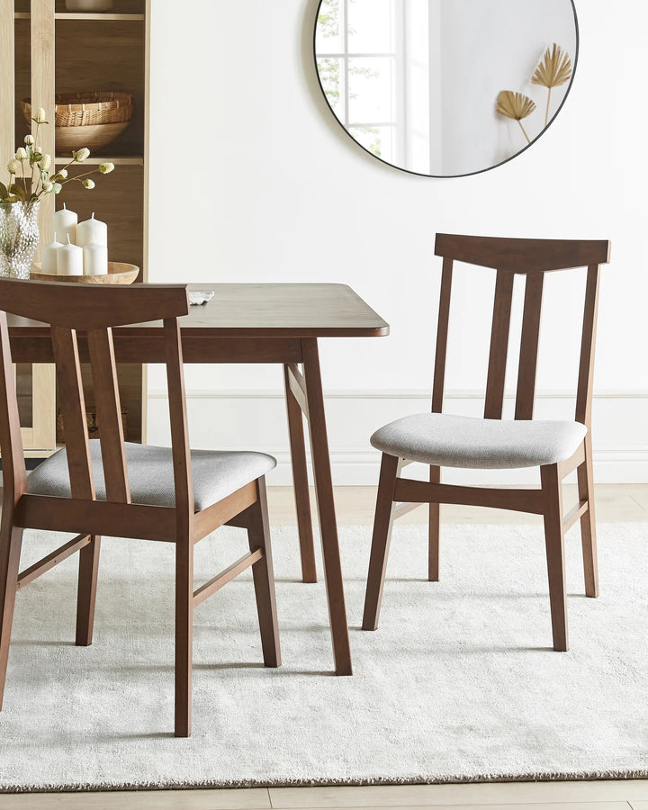 Styled around a coordinating dining table, this dark wood dining chair brings warmth and sophistication to the dining area. The contrasting grey upholstery softens the look, creating a welcoming and refined setting.