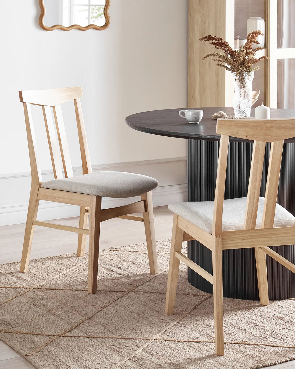 Styled around a modern dining table, this wooden dining chair adds warmth and simplicity to the space. The natural wood frame and neutral upholstery create a comfortable and inviting dining setting.
