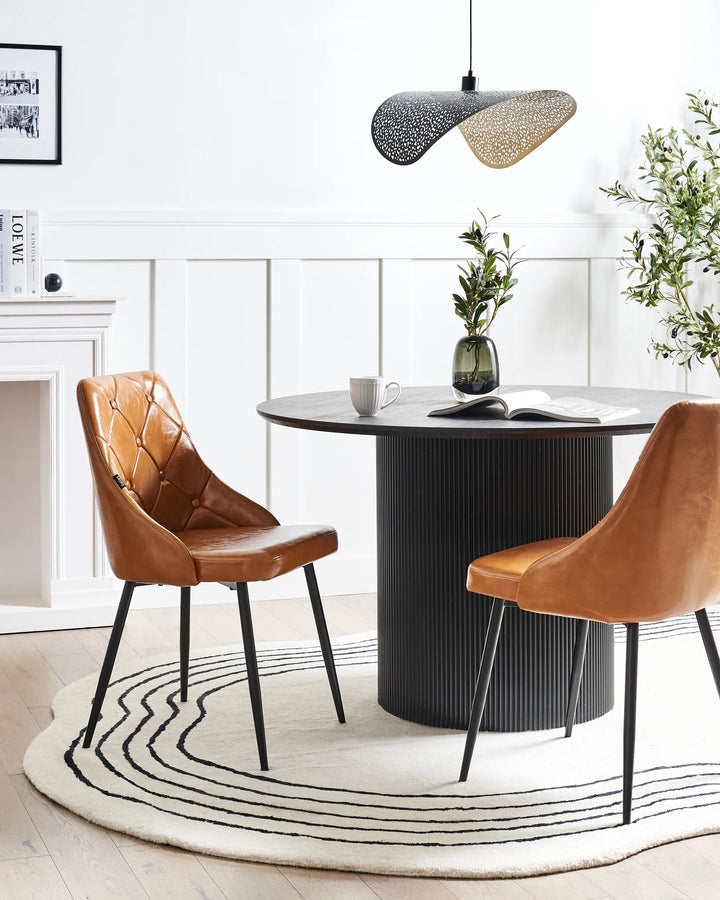 Elegant dining setup featuring the chair’s warm brown upholstery and quilted backrest, paired with a black dining table for a sophisticated modern-industrial aesthetic.