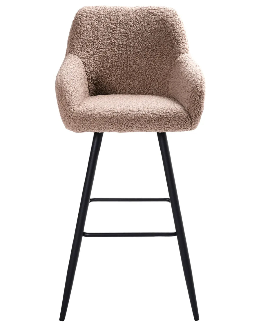 Taupe bouclé bar chair with a rounded upholstered backrest, padded seat with integrated armrests, and slanted black metal legs.
