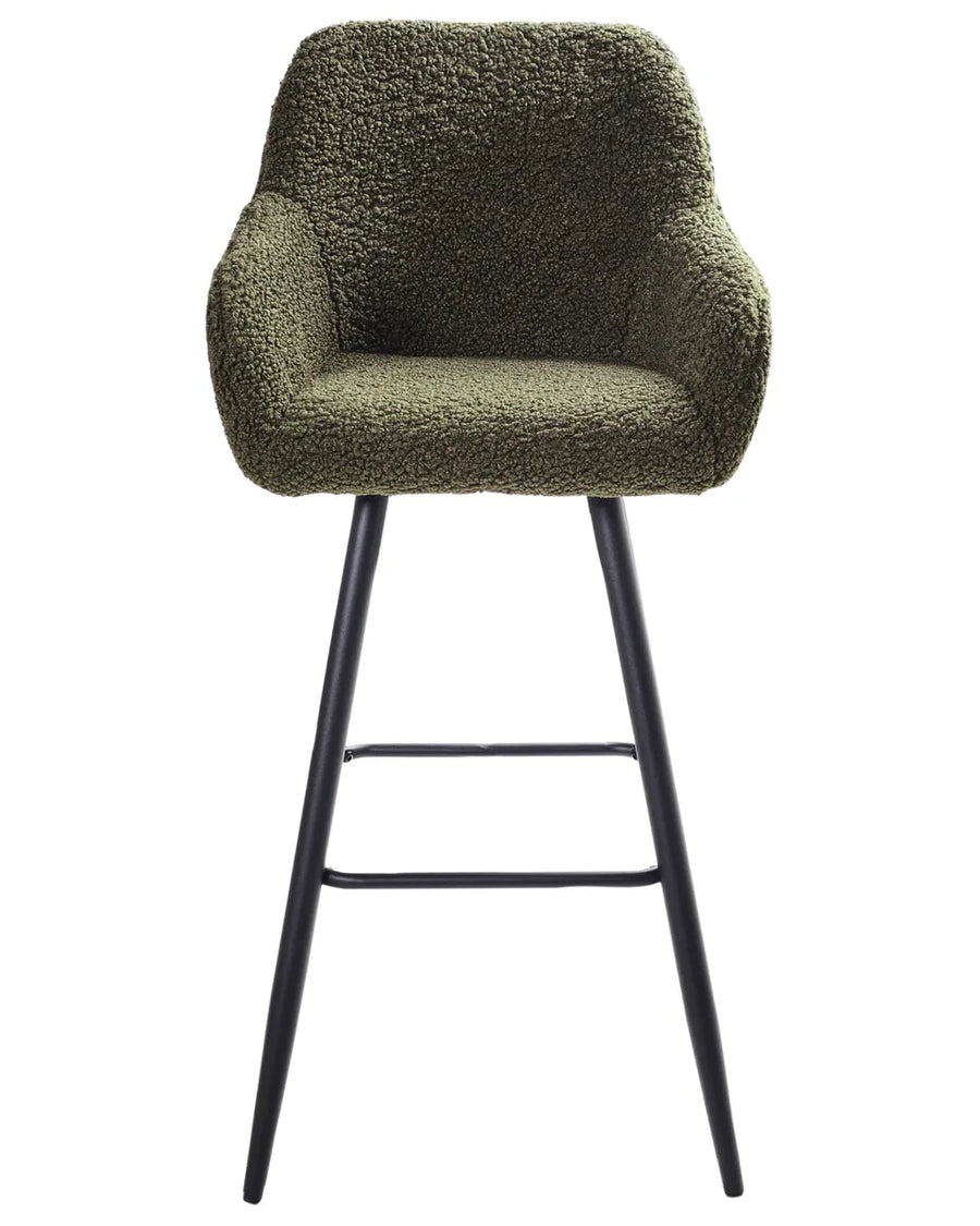 Dark green bouclé bar chair with a rounded upholstered backrest, padded seat with integrated armrests, and slanted black metal legs.
