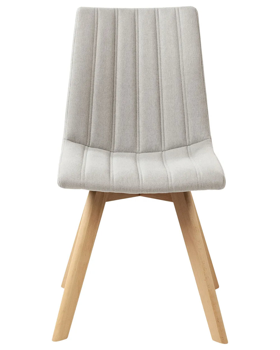 Light grey upholstered dining chair with vertical channel stitching, a high backrest, and natural wood legs.