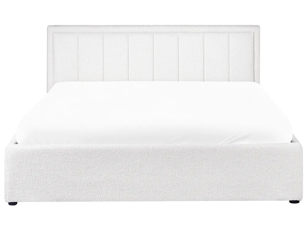 White upholstered bed with a headboard on a white background