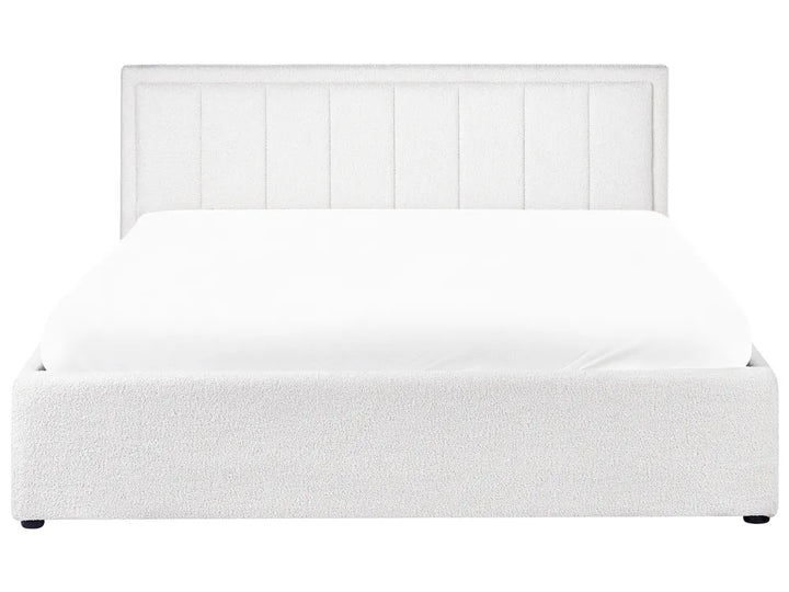 White upholstered bed with a headboard on a white background