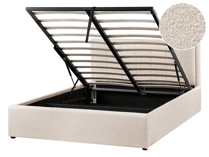Beige upholstered bed frame with black metal slat support on a white background