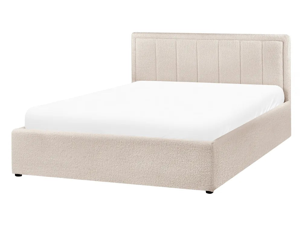 Beige upholstered bed with white mattress on a white background