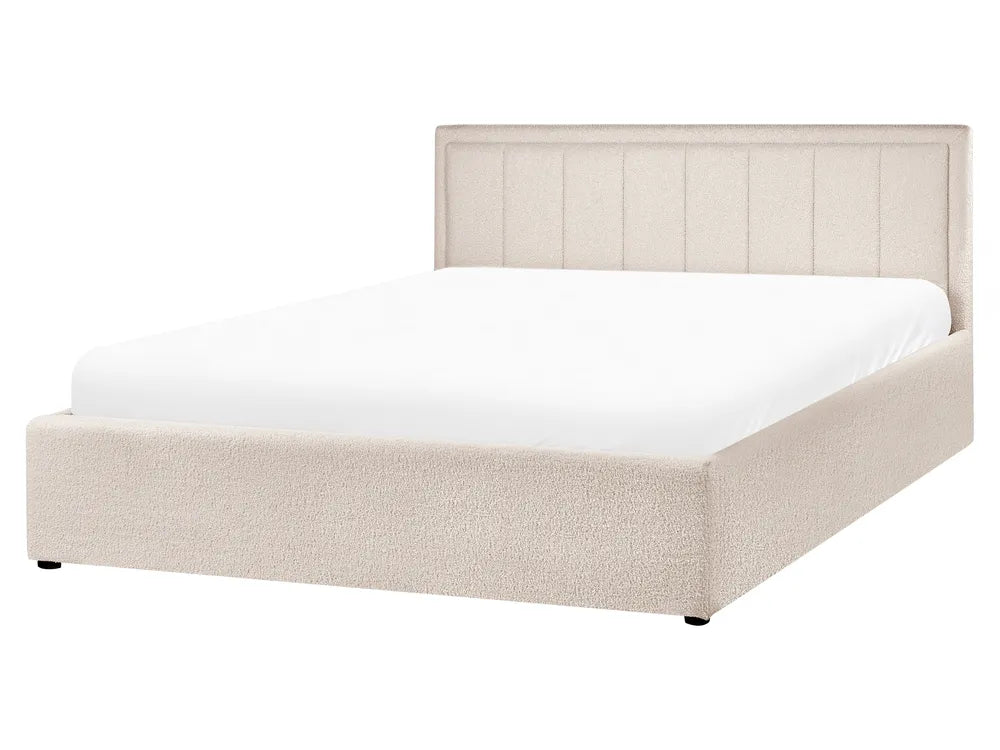 Beige upholstered bed with white mattress on a white background