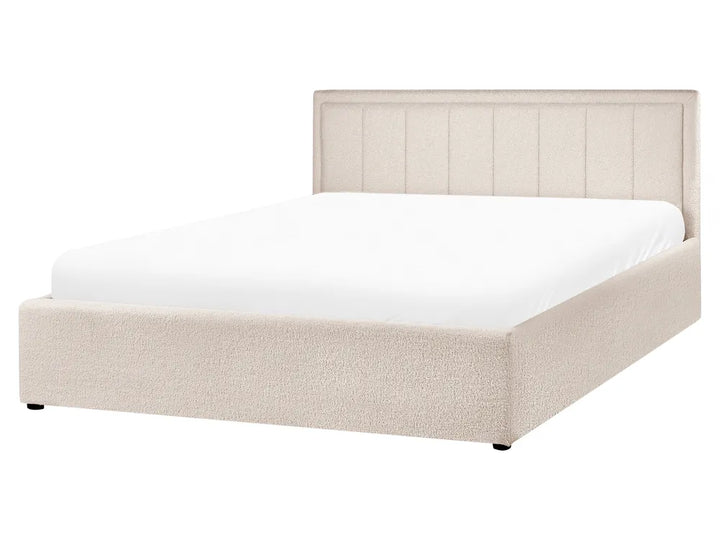 Beige upholstered bed with white mattress on a white background