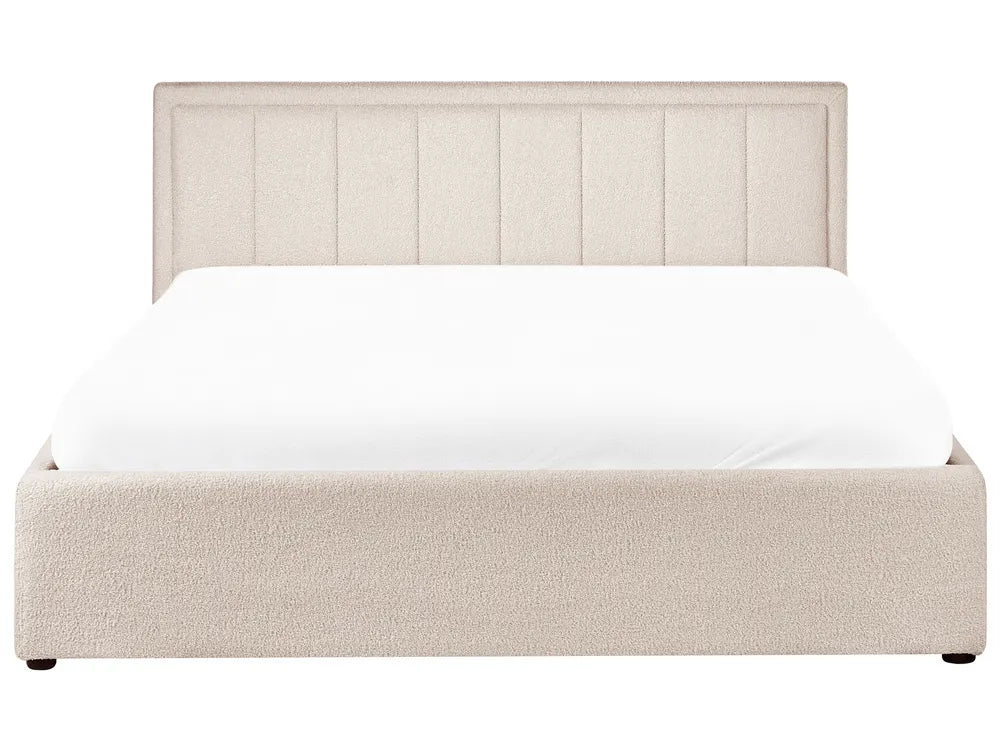Beige upholstered bed with white mattress on a white background