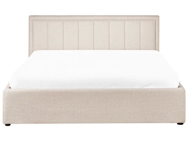 Beige upholstered bed with white mattress on a white background