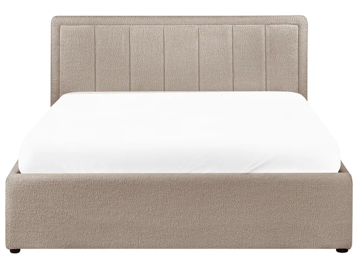 Beige upholstered bed with white mattress on a white background