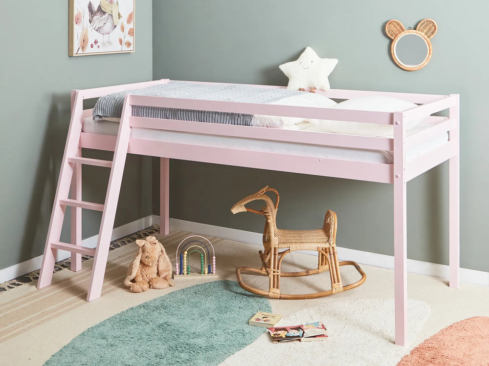Pink children's bed in a room with toys and decor