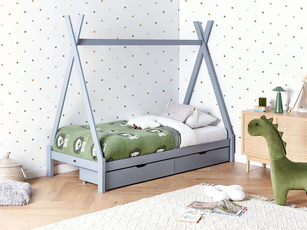 Children's bedroom with a gray teepee bed, green dinosaur toy, and polka dot wallpaper.