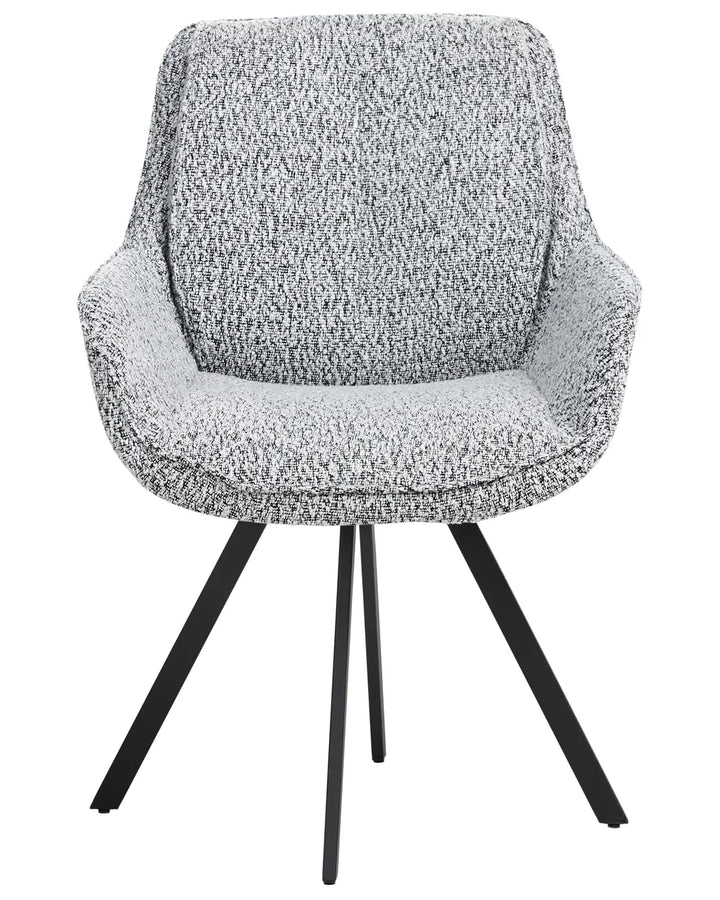 Black and white speckled bouclé swivel dining chair with a curved upholstered backrest, integrated armrests, and powder-coated metal legs.
