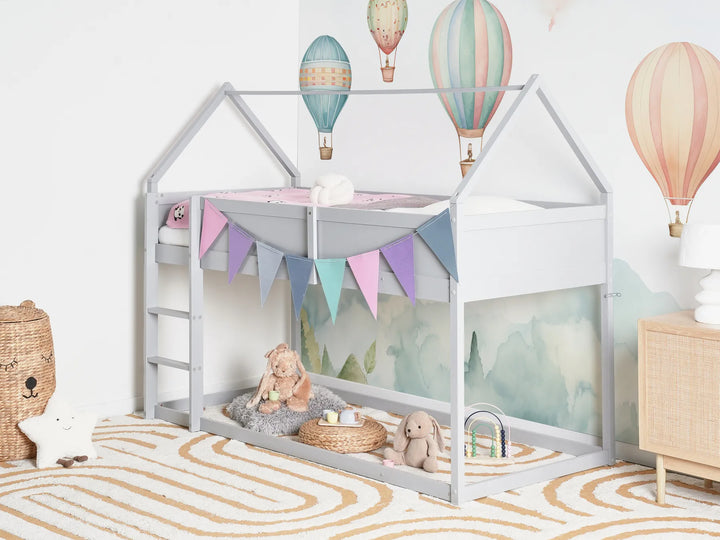 Children's room with a house-shaped bed, toys, and colorful hot air balloons on the wall.
